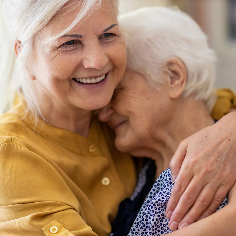 Elderly women hugging