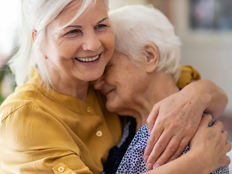 elderly women hugging
