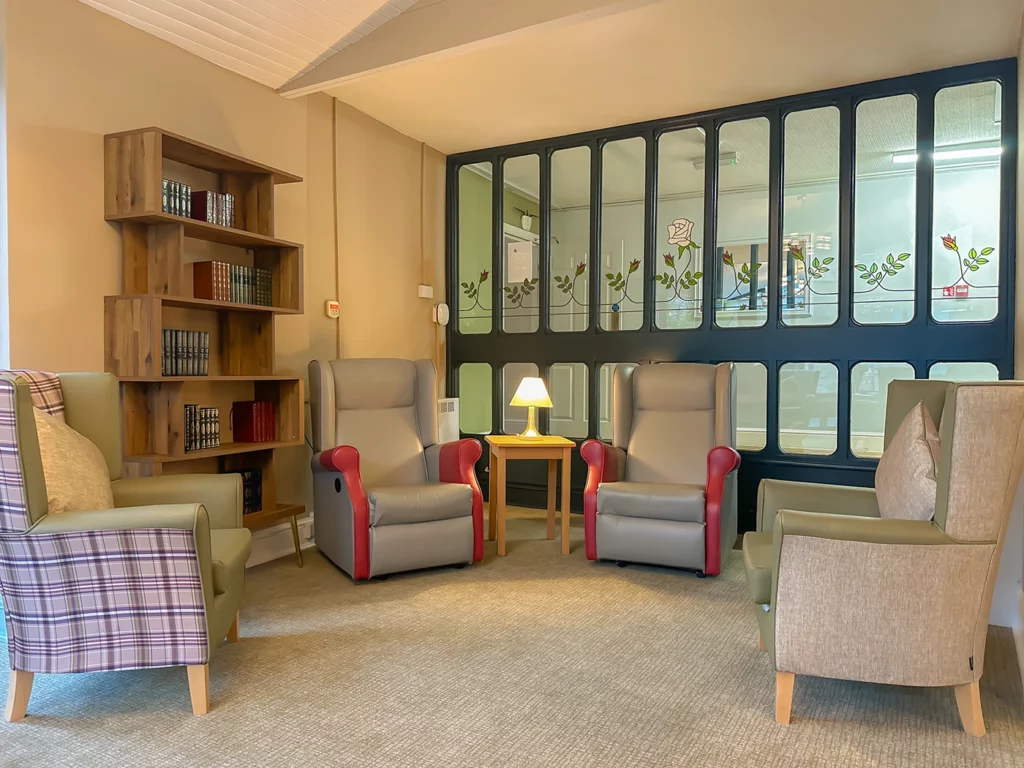 picture of lounge with chairs and book shelf