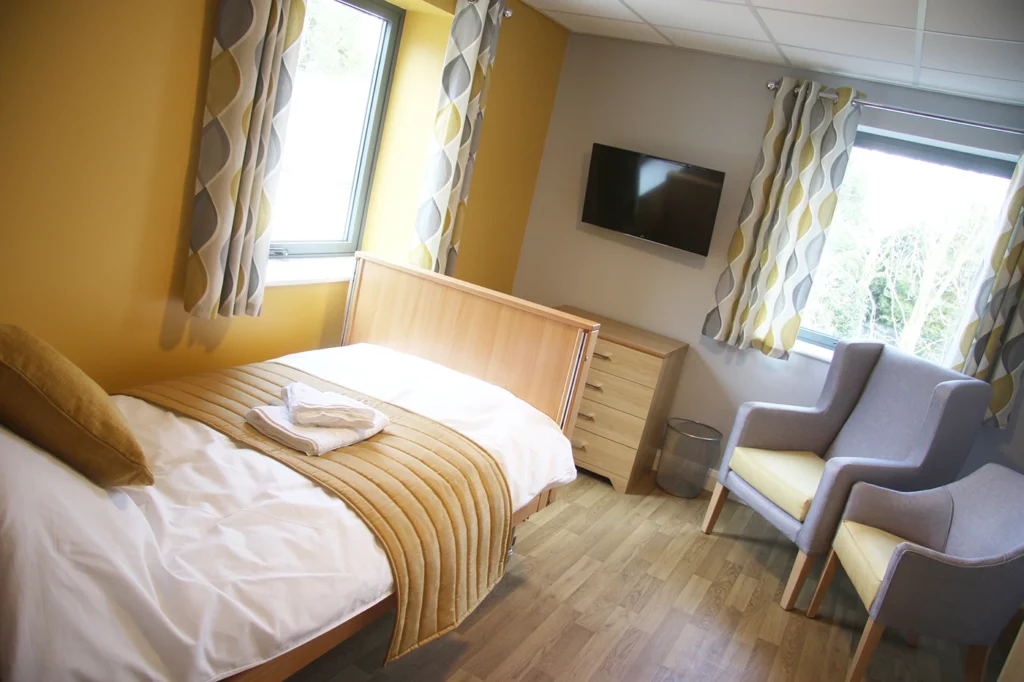 Leyland bedroom with bed, chairs and TV